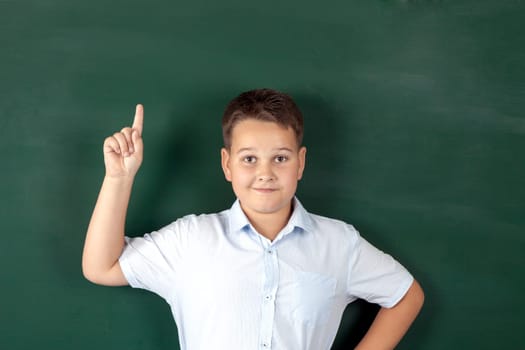 boy in a shirt with school boards with bulb and idea