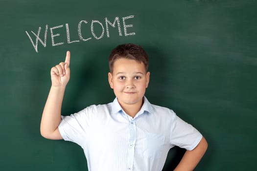 boy in a shirt with school boards with bulb and idea