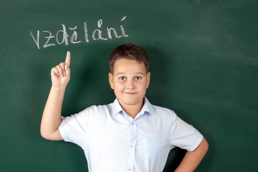 boy in a shirt with school boards with bulb and idea