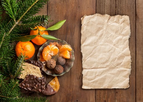Chocolate, truffles and tangerins with fir and craft paper