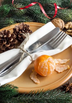 Festive table setting with spices and tangerine on wood