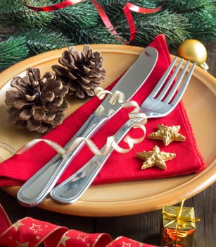 Festive table setting with red napkin and rustic plate