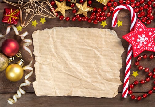Christmas composition with decorations and paper on wood
