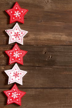 Christmas red and white stars on wooden background