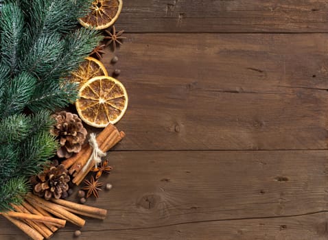 Christmas composition with spices and branches on wood