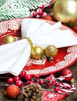 Festive table setting with Christmas decorations on wooden table