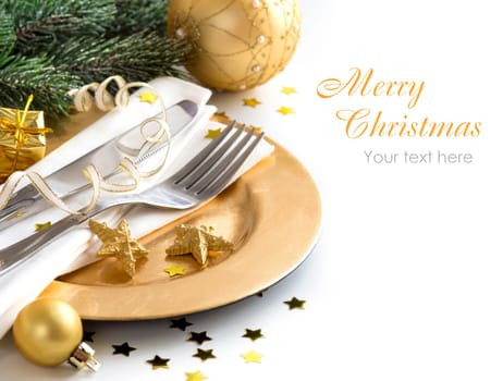 Festive table setting with golden bauble and plate