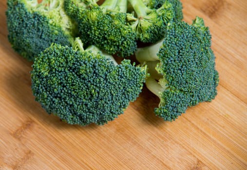  close up on fresh broccoli solated on wooden background