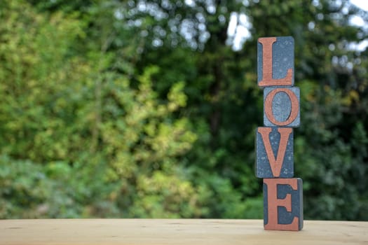 Building blocks with Love lettering stacked up against a natural background