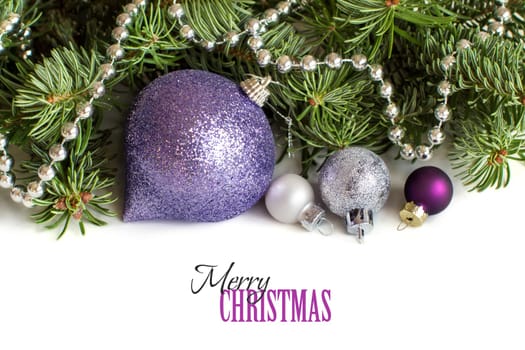 Silver and purple Christmas ornaments border on white background