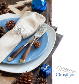 Christmas table setting with rustic decorations on wood