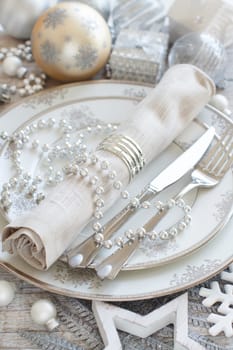 Silver and cream Christmas Table Setting with christmas decorations