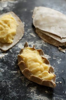 Traditional karelian pasties with potatoes before oven