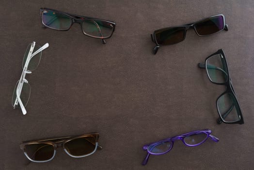 Collection of glasses and sunglasses with copyspace in the center