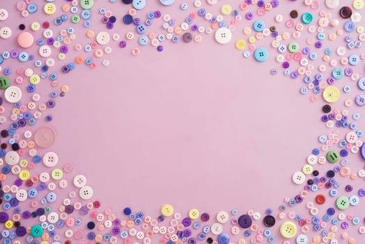 Collection of buttons in pink and pastel colours on pink background with copyspace