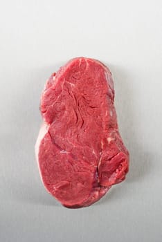 Uncooked fillet steak on stainless steel from above