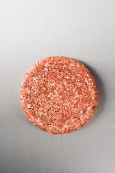Burger patty from ground beef on stainless steel