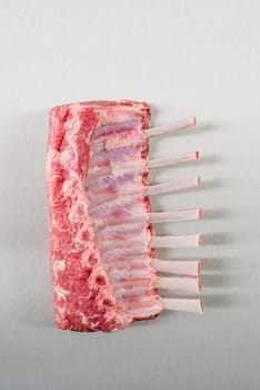 Raw rack of lamb on stainless steel