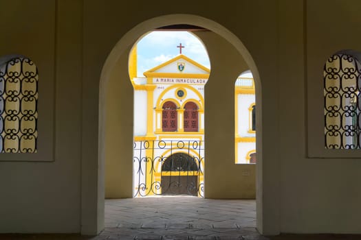 Church in Mompox, Colombia seen through an arch in the historic town market