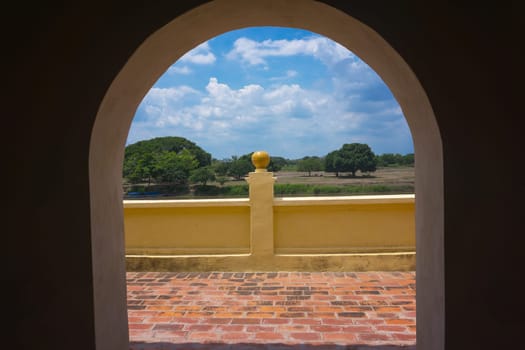 Landscape in Mompox, Colombia viewed through an arch in the historic town market