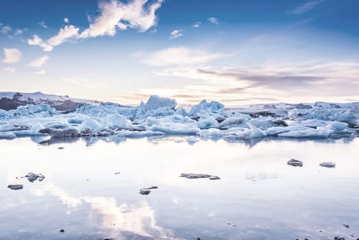Scenic view of icebergs in Jokulsarlon glacier lagoon, Iceland, at sunset, selective focus, cool vintage style effect