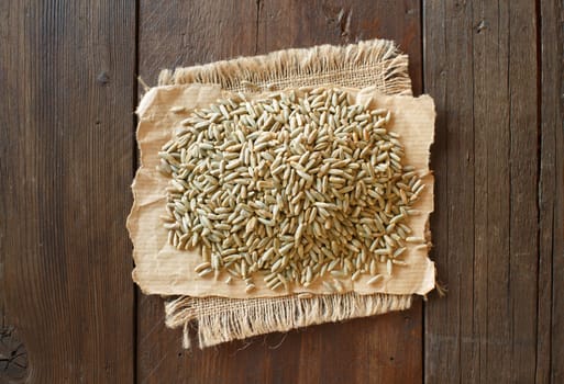 Dry Raw Rye Grain top view on wood