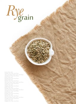 Dry Raw Rye Grain in a bowl top view isolated on white