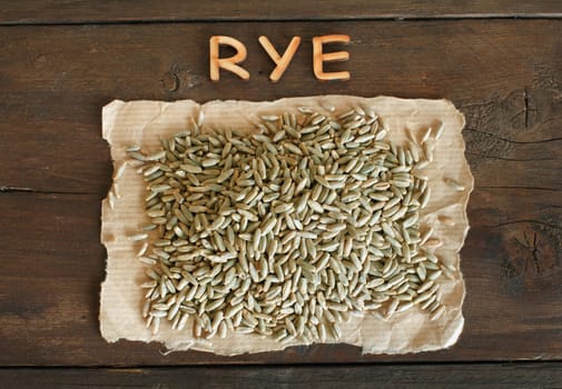 Pile of Dry Raw Rye Grain with wooden letters