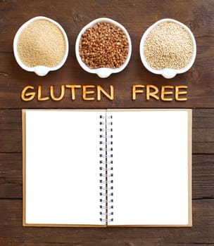 Amaranth, buckwheat and quinoa with notebook and wooden letters