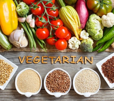 Fresh vegetables and cereals with word Vegetarian top view