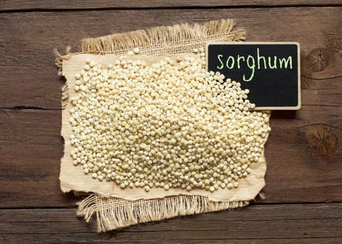 White Sorghum grain with a small chalkboard top view
