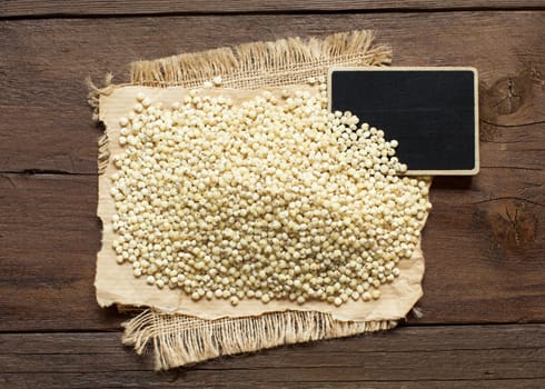 White Sorghum grain with a small chalkboard top view