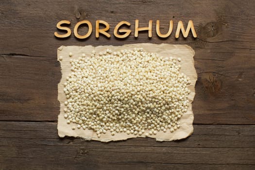 White Sorghum grain with wooden letters on the wooden table