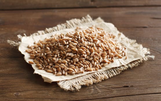 Pile of Uncooked whole spelt on the table