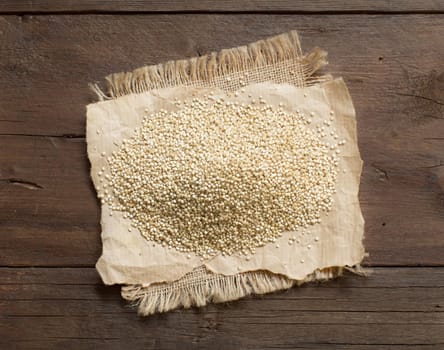 Pile of White Quinoa on a wooden table top view