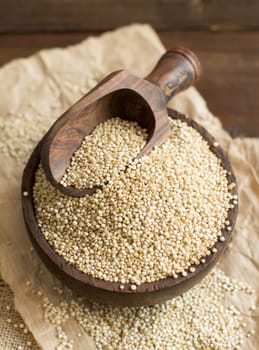 White Quinoa with a wooden spoon and bowl close up