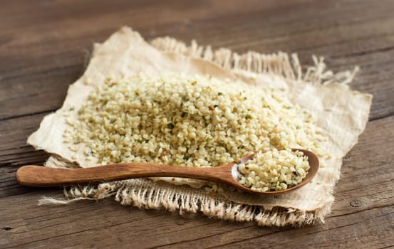 Pile of Uncooked Hemp seeds with a spoon close up