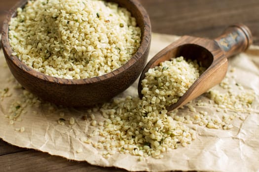 Pile of Uncooked Hemp seeds in a bowl with a spoon