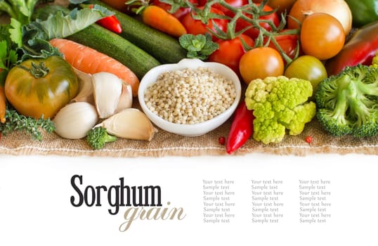 White sorghum grain in a bowl with vegetables isolated on white