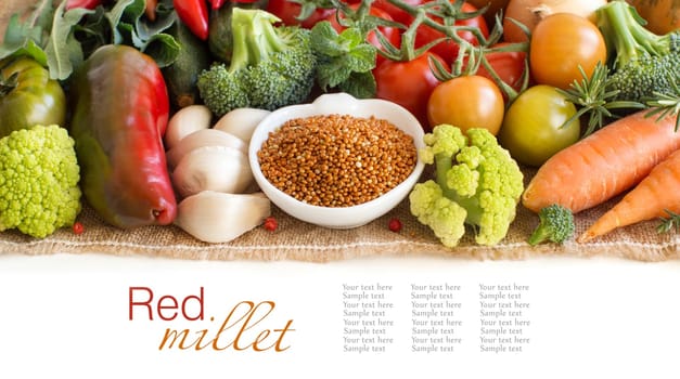 Uncooked red millet in a bowl with vegetables