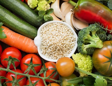 White sorghum grain in a bowl with vegetables top view