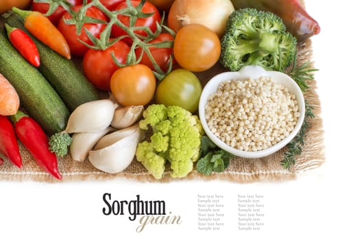 White sorghum grain in a bowl with vegetables isolated on white
