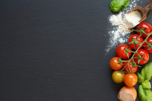 Ingredients of italian cuisine: tomatoes, basil, eggs, flour