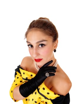 A closeup image of a gorgeous young woman in a yellow dress and.wearing black cloves and jewellery, isolated for white background..