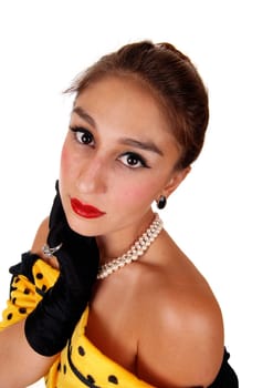 A beautiful young woman in a yellow dress and black cloves looking up.into the camera, isolated for white background..