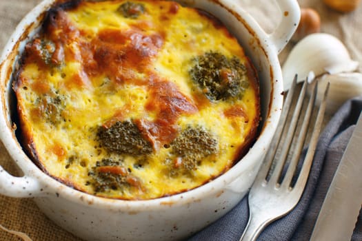 Casserole with broccoli on a rustic background closeup