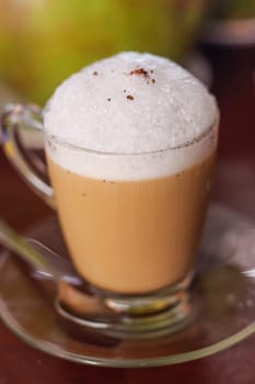 A cup of cappuccino on wooden table