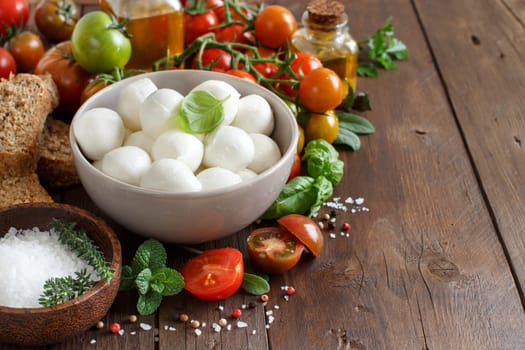 Italian food ingredients for caprese salad on wooden background