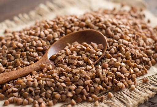 Buckwheat with a spoon on a wooden table