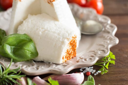 Italian ricotta cheese, vegetables and herbs close up